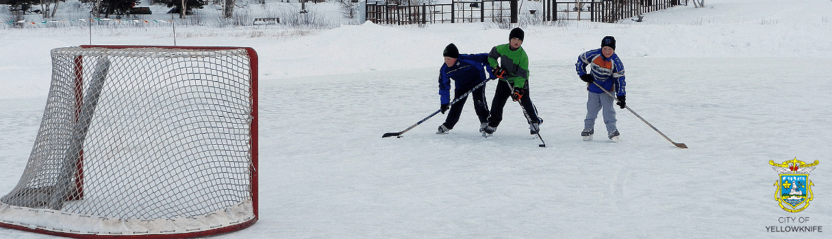 three kids playing hockey
