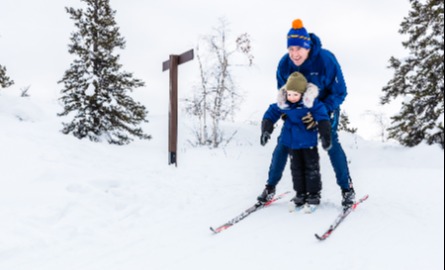 Image of Man and child skiing