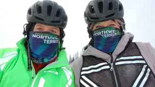 Two cyclists wearing a helmet 