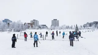 People playing tennis on the frozen lake 