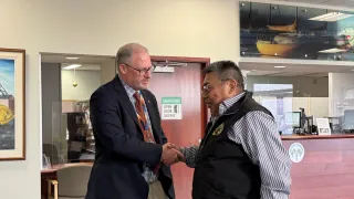 Stephen Van Dine shaking hands with Chief Sangris 