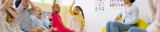 kids raising hands in a circle