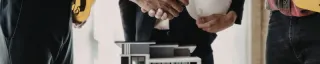 Three people shaking hands confirming a deal