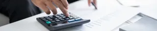 Man calculating taxes with his calculator