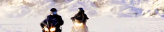 A pair snowmobile on the frozen lake 