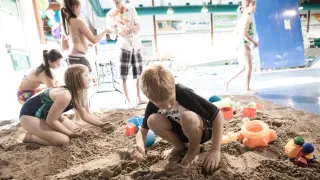 Kids playing in sand at the pool 