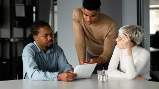 a group of 3 discussing about taxes