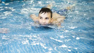 Boy swimming in pool 