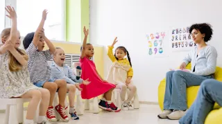 kids raising hands in a circle