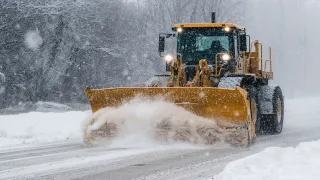 Winter Road cleaning with heavy machine