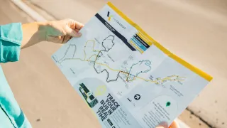 A person reading the YK Transit Map